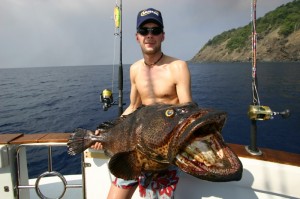 A tourist shows is catch after a session of game fishing