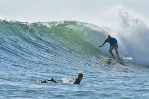 A surfer negotiates a tide at a beach in the Little Andaman Islands.