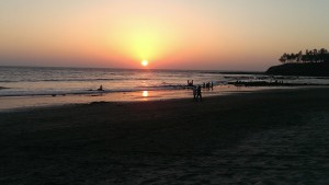 Tourist enjoy a view of the sunset at a deserted beach during the monsoons in Tarkarli
