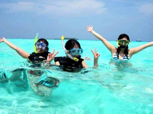 Youngsters having a good time enjoying snorkeling at Tarkarli beach