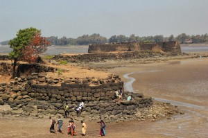 Tourist explore the ruins of the Sarjekot Fort