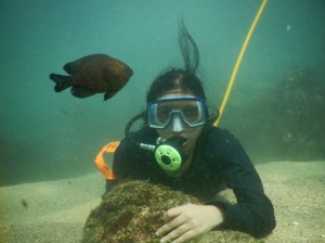 The diver enjoys her Kodak moments underwater.