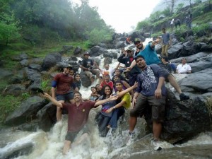 Trekkers enjoy themselves at a waterfall 